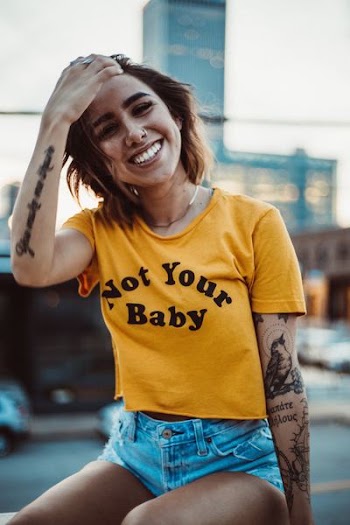 woman wearing yellow shirt and short shorts
