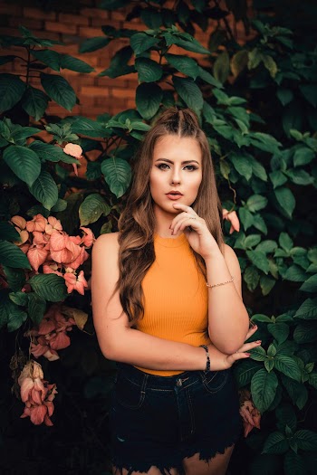 Woman Wearing Yellow Sleeveless Tops Beside Plant