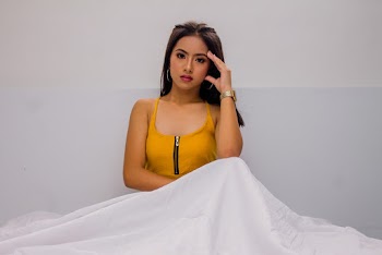 Woman Wearing Yellow Spaghetti Strap Top Holding Her Face