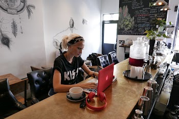 Woman Wears Black Kiss Print Crew-neck Shirts Sits