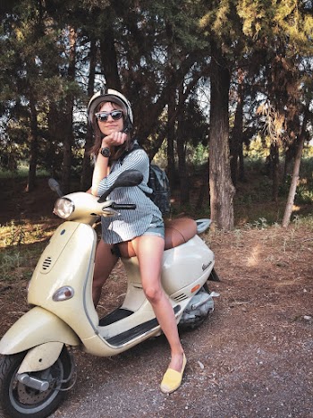 Woman Wears Helmet on Beige Motor Scooter