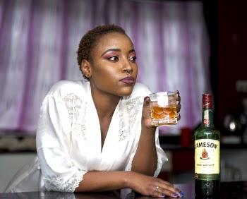 Woman Wears White Lace Bathrobe Holds Shot Glass