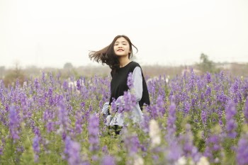 Woman With Black and White Long-sleeved Top on Garden