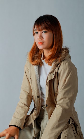 Woman With Blonde Hair Wearing A Beige Jacket