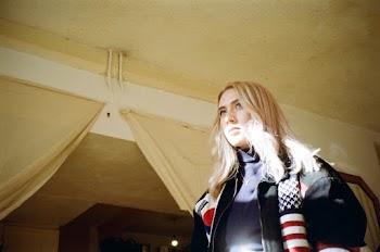 Woman With Blonde Hair Wearing A Sports Jacket