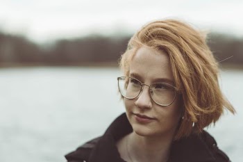 woman with blonde hair wearing eyeglasses