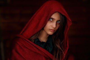 woman with blue eyes wearing red shawl