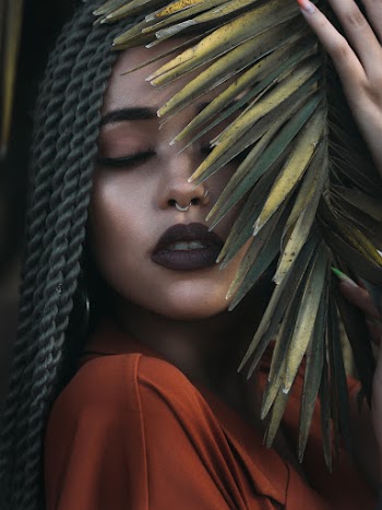 Woman With Braided Hair Touching Leaves