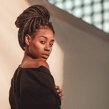 Woman With Braided Hair Wearing Black Top 