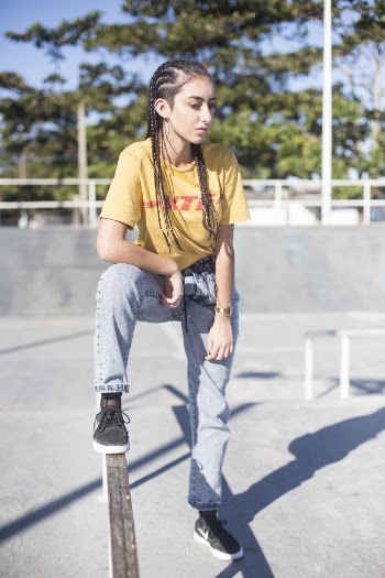Woman With Braided Hair Wearing Yellow Shirt and Jeans at the Park