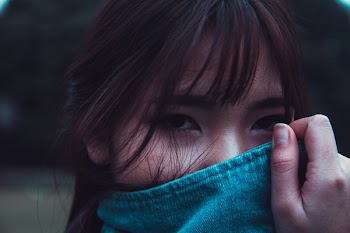 Woman With Brown Hair Covering Face With Blue Denim Coat