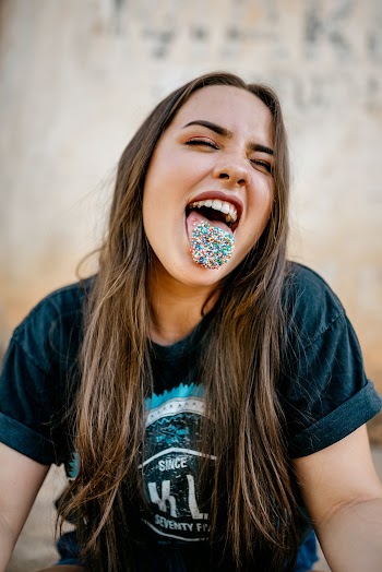 Woman With Candies on Tongue