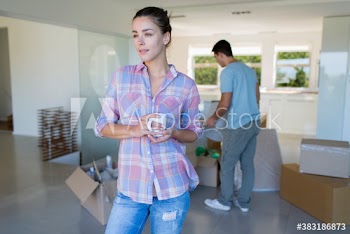 Woman with coffee taking a break from moving in new house