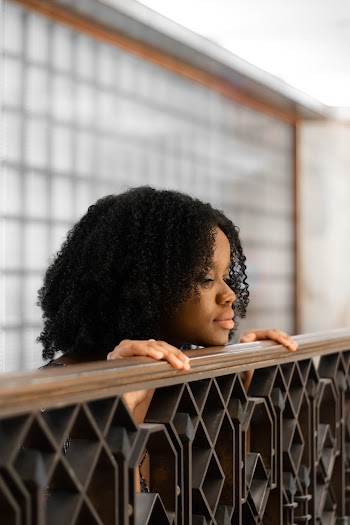 Woman with Curly Hair Leaning on Railings