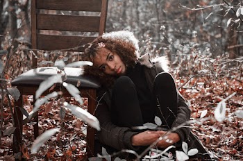 Woman with Curly hair Resting Her Head on Wooden Chair