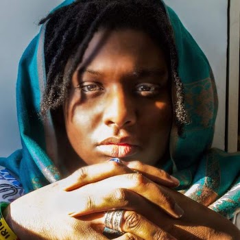 Woman With Dreaded Hair Wearing Green Hijab