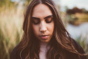 woman with eyes closed in closeup photography