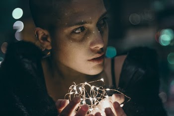 Woman With Fairy Lights On Her Hands