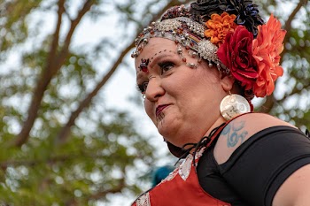 Woman With Floral Headdress Near Green Trees