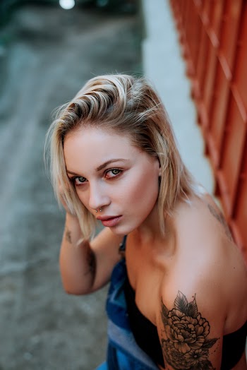 Woman With Floral Tattoo on Her Left Shoulder