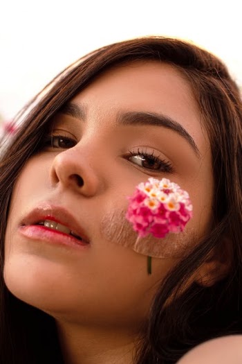 Woman with flower on cheek · Free Stock Photo