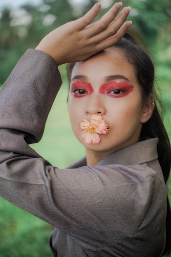 Woman with Flower on Her Mouth