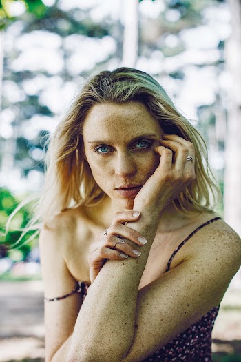 Woman With Left Hand On Cheek