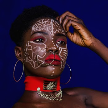 Woman With Nose Ring and Earrings Touching Her Hair
