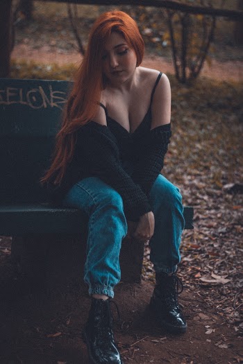 Woman with Red Hair Sitting on Bench
