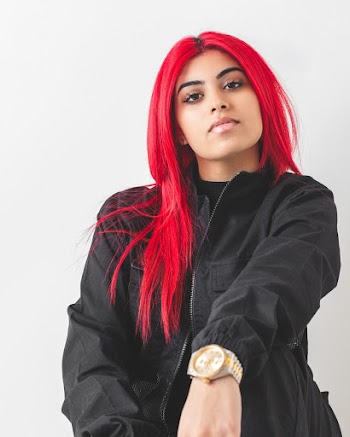 Woman With Red Hair Wearing A Black Jacket