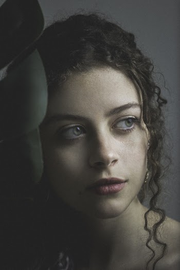 Woman With Red Lips Leaning on Green Garment in Selective Focus Photography