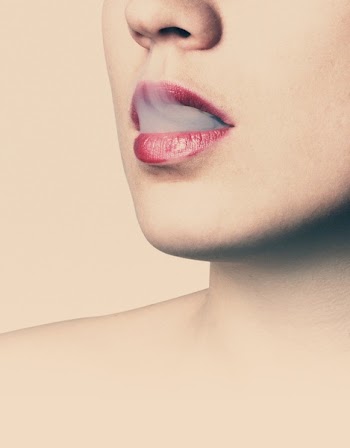 Woman With Red Lipstick Letting Smoke Out from Her Mouth Then Inhales It Again With Her Nose