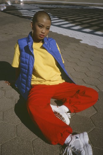 Woman with Short Hair Sitting on Cobblestone 