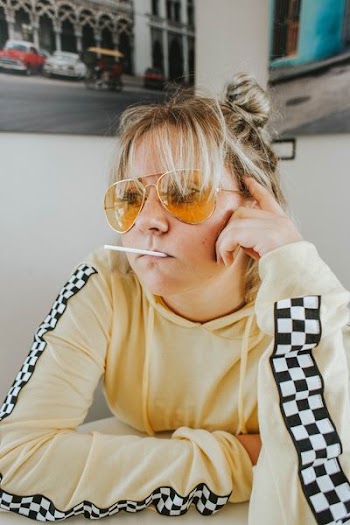 woman with sunglasses sitting in front of table