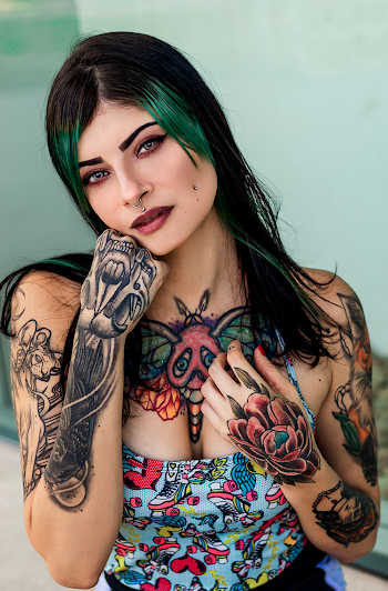 Woman With Tattoos Holding Her Face