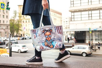 Woman With White and Beige Woman's Face Printed Tote Bag Walking in Street