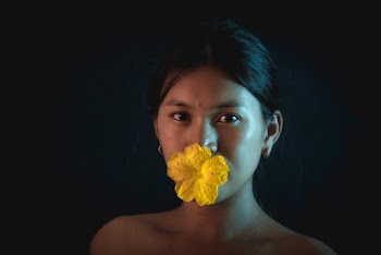 Woman With Yellow Flower on Her Lips
