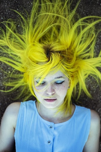Woman With Yellow Hair Lying On The Ground