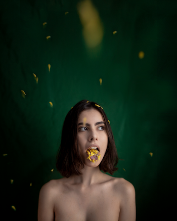 Woman With Yellow Petals on Tongue