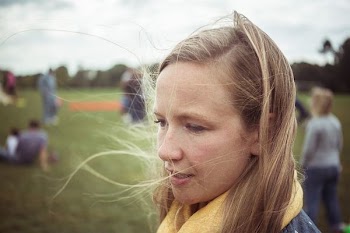 woman with yellow scarf near other people