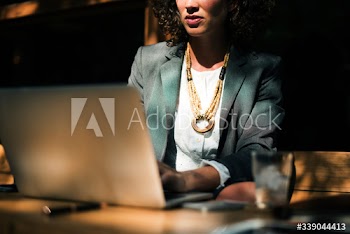Woman working with laptop at coffee shop