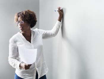 Woman Writing in White Board