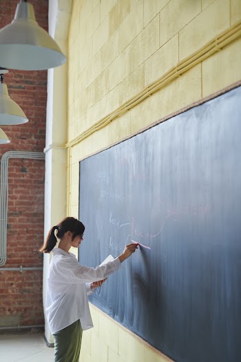 Woman Writing on Board