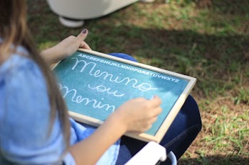 Woman Writing on Chalkboard