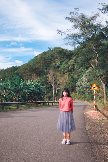 Womans Standing on Road Wearing Pink and Gray Dress