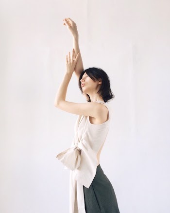 Women's Beige Sleeveless Blouse Raising Hands
