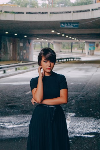Women's Black Dress Standing on Street