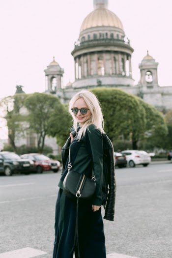 Women's Black Jacket and Black Skirt Near Building