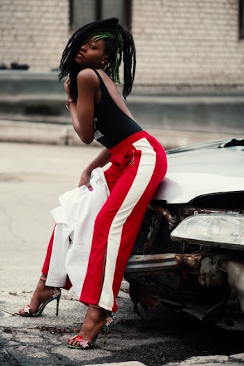 Women's Wearing Black Backless Top With Red and White Pants