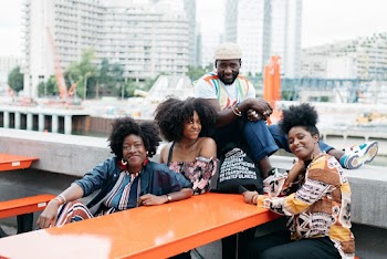 Women and Man Posing at Table